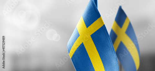Foto Small national flags of the Sweden on a light blurry background