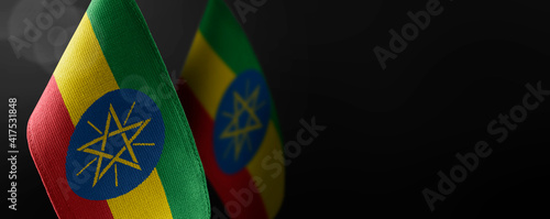 Small national flags of the Ethiopia on a dark background photo