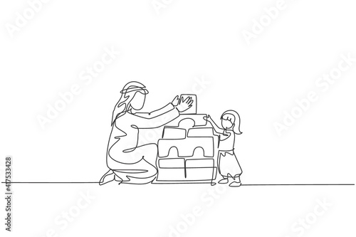 One single line drawing of young Islamic dad playing block foam puzzle house with his daughter at home vector illustration. Happy Arabian family parenting concept. Modern continuous line draw design