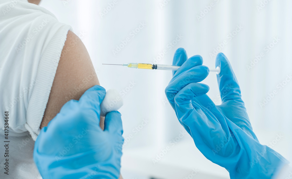 Female doctors vaccinated with syringes to prevent epidemics at hospitals, health care, and medical concepts Female doctors vaccinated with syringes to prevent epidemics at hospitals, health care, and medical concepts