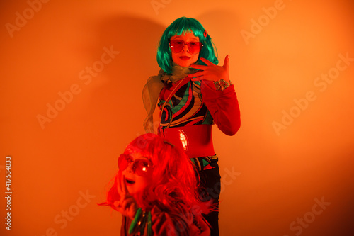 Little girls wearing a colorful wigs posed for a photo shooting