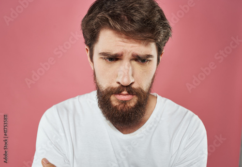 bearded man showing thumb to the side on pink background cropped view Copy Space