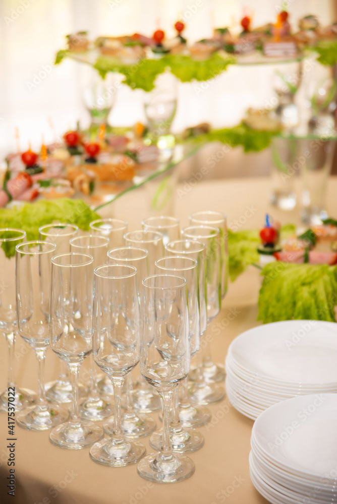 Empty glasses set, Elegant table setting for a festive dinner in the restaurant. Snacks on the buffet table Empty glasses set, Elegant table setting for a festive dinner in the restaurant. Snacks on the buffet table