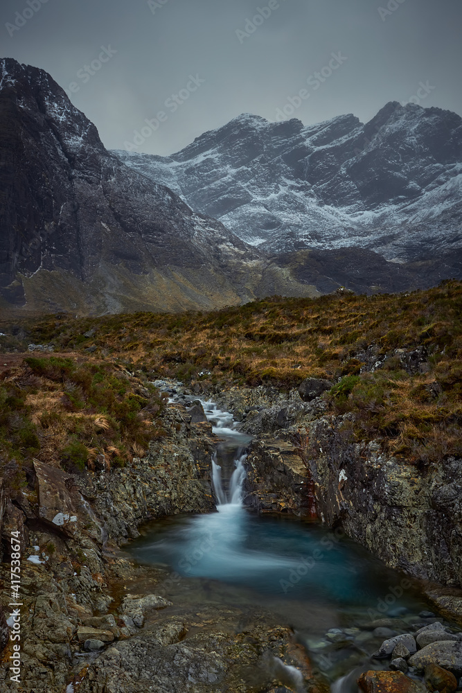 mountainous valley with river, waterfall and lake. concept of nature, freedom, tourism, trekking - Fairy Pools - Skye Island - Scotland - Uk