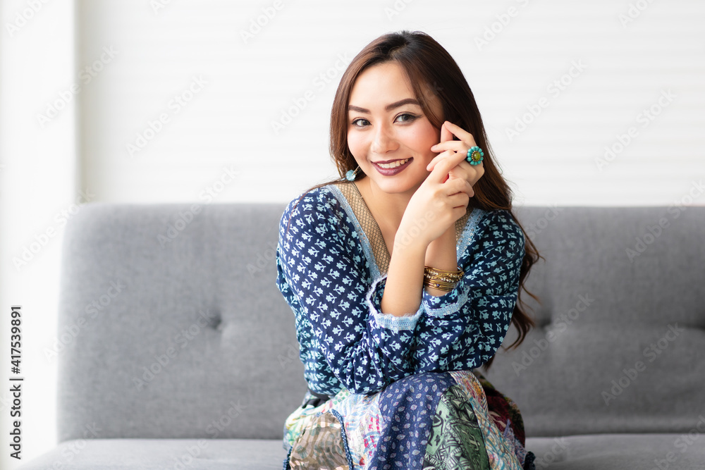 Young, beautiful and friendly face girl smile, dressed casually with happy and self-confident  expression to camera sitting on sofa. Concept for good attitude emotion