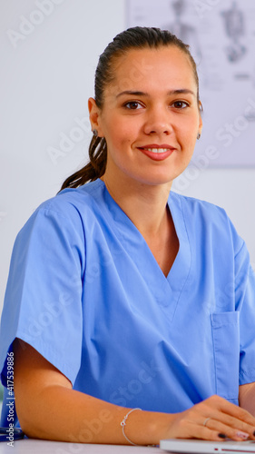 Portrait of professional medical nurse in blue practitioner uniform smiling at camera. Hospital healthcare worker, medicine clinical assistant health consultant therapist, telemedicine and healthcare