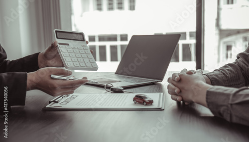 Car salesman offers prices and conditions for buying or renting a car to a customer, Entering into a car purchase-sale agreement with insurance, Way of business people conversation.
