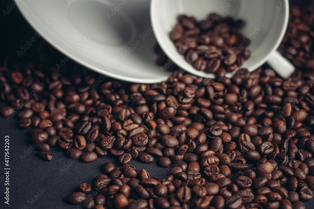 cup of coffee with brown beans on a gray background close-ups macro photography cup of coffee with brown beans on a gray background close-ups macro photography