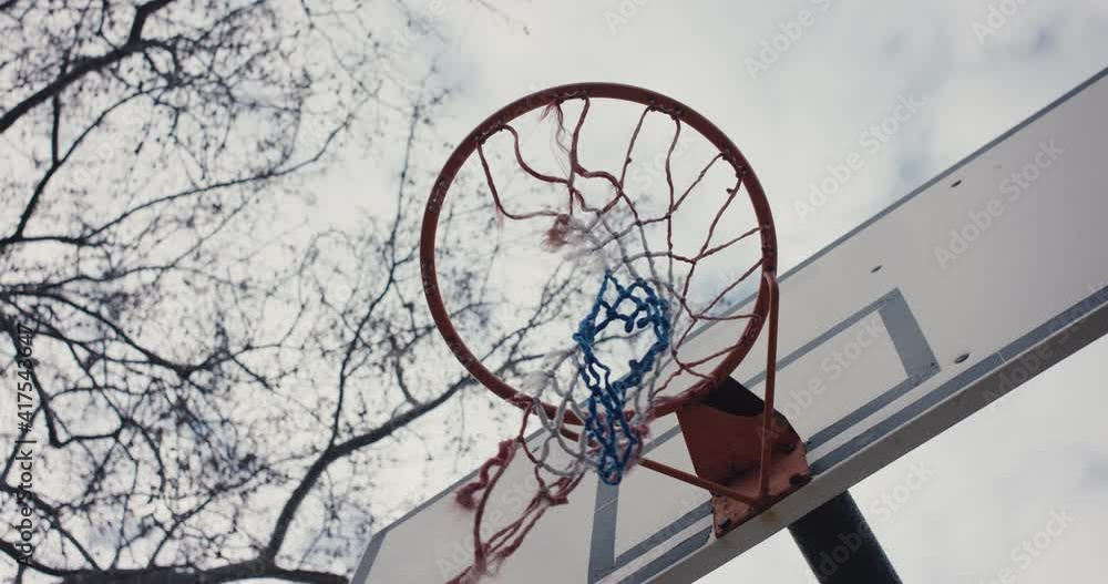 Empty basketball sport hoop torn net eerie Covid 19 pandemic lockdown Empty basketball sport hoop torn net eerie Covid 19 pandemic lockdown