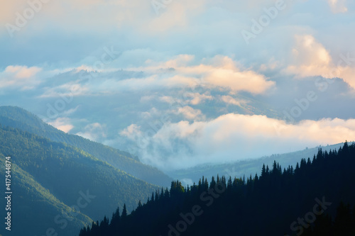 Bright Carpathian landscape in the morning light. After a thunderstorm. Rising fog. © lesia