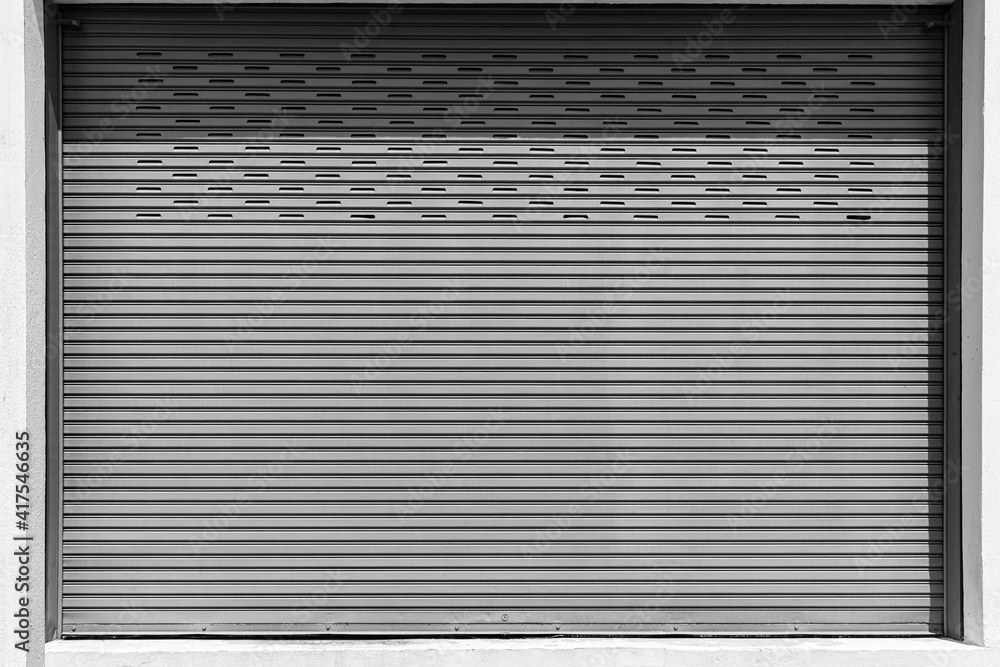 Fototapeta premium Closed Silver metal shutter garage door at home