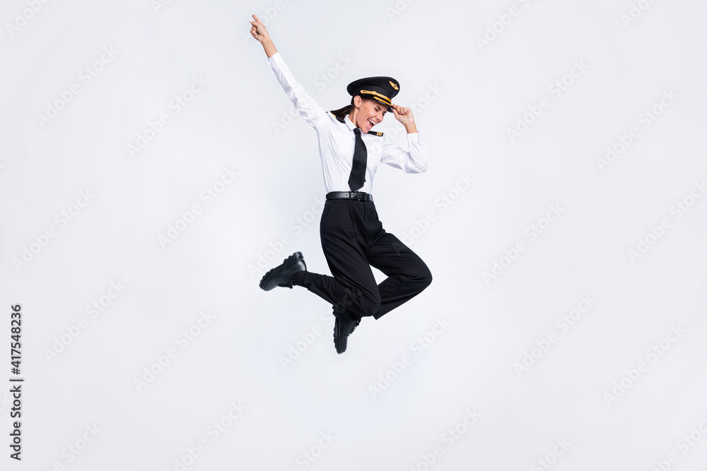 Full length body size view of attractive overjoyed cheerful pilot girl jumping having fun isolated over white color background