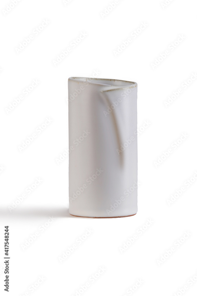 Subject shot of white ceramic vase with glazed surface. The cylindrical Scandinavian bowl with bevil neck is isolated on the white background. Subject shot of white ceramic vase with glazed surface. The cylindrical Scandinavian bowl with bevil neck is isolated on the white background.