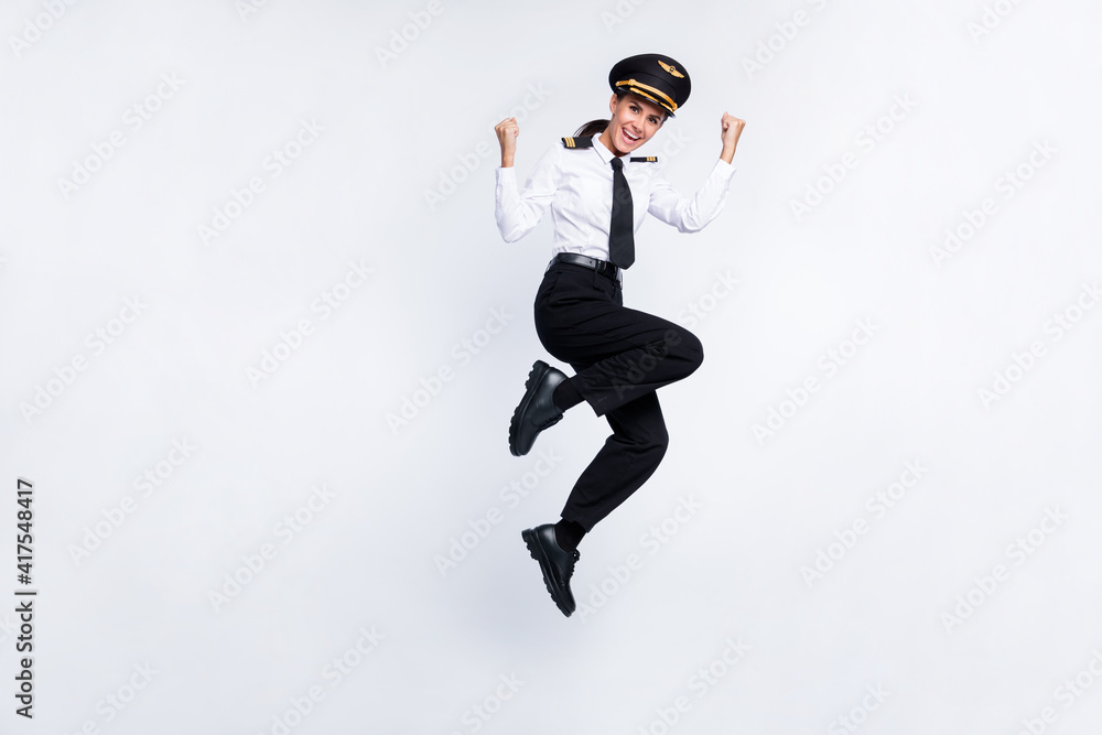 Full length body size view of pretty cheerful pilot girl jumping having fun attainment isolated over white color background