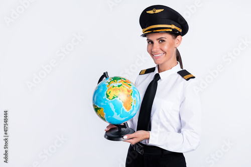 Portrait of attractive cheerful pilot girl holding in hands globe business trip continent isolated over white color background