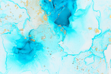 art photography of abstract fluid art painting with alcohol ink, blue and gold colors