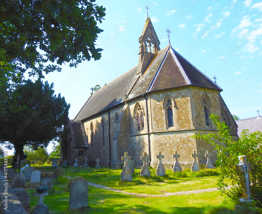 View of an old English church in the countryside with a cemetery