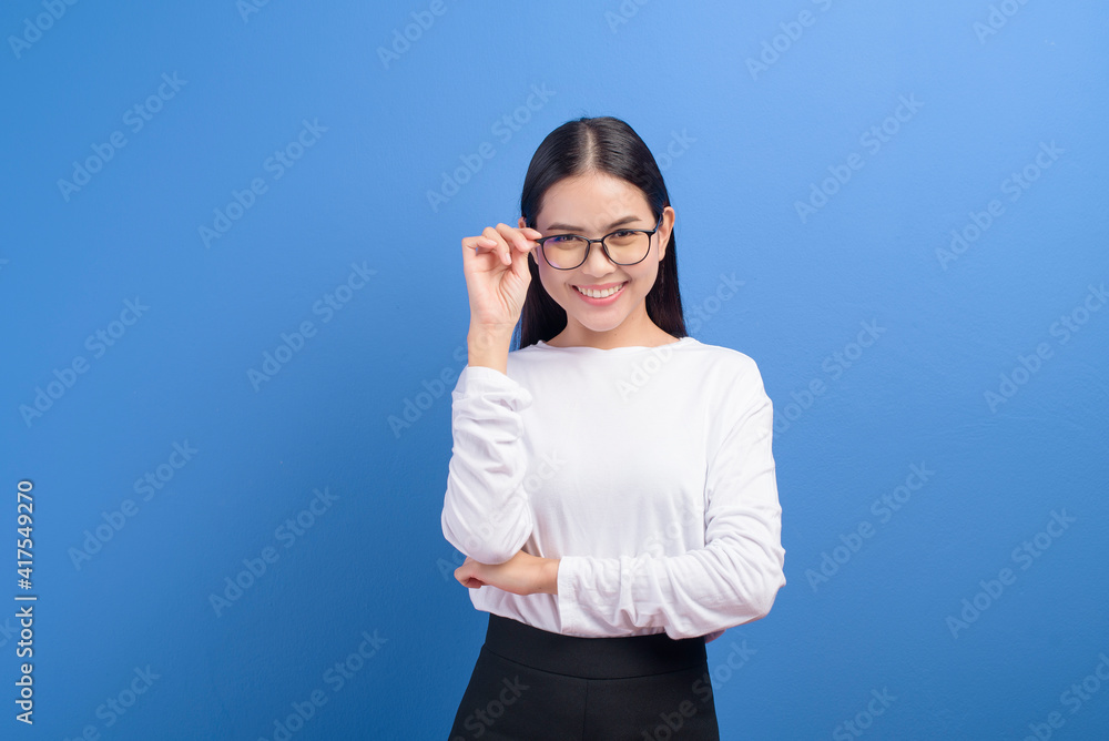 Portrait of young female wearing glasses over blue background studio, healthcare concept Portrait of young female wearing glasses over blue background studio, healthcare concept