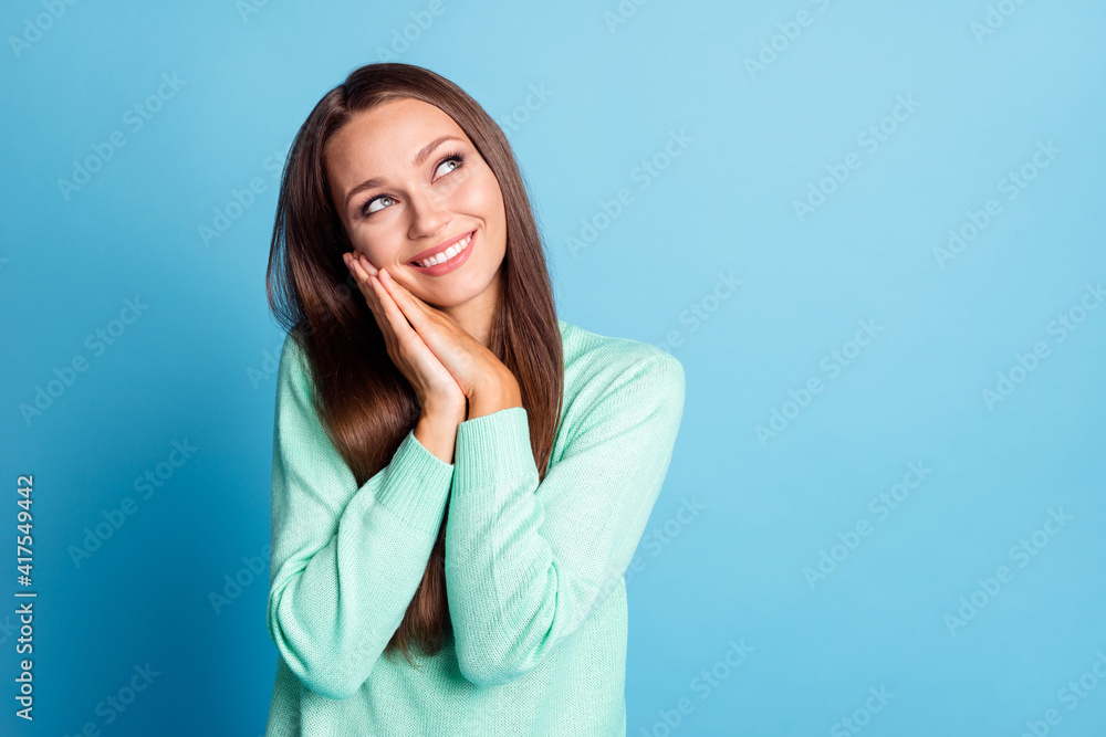 Photo portrait of dreamy girl with hands under head isolated on pastel blue colored background Photo portrait of dreamy girl with hands under head isolated on pastel blue colored background