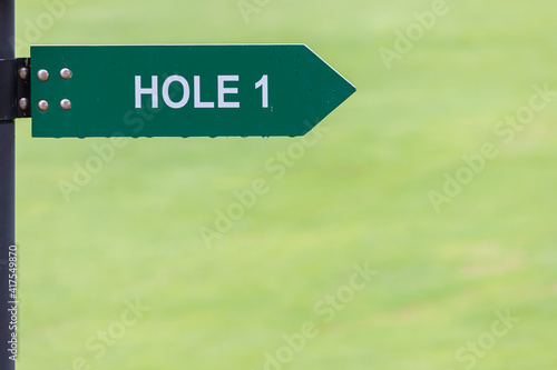 Fotografie Signs for the tee off at the golf course, hole 1 with green background