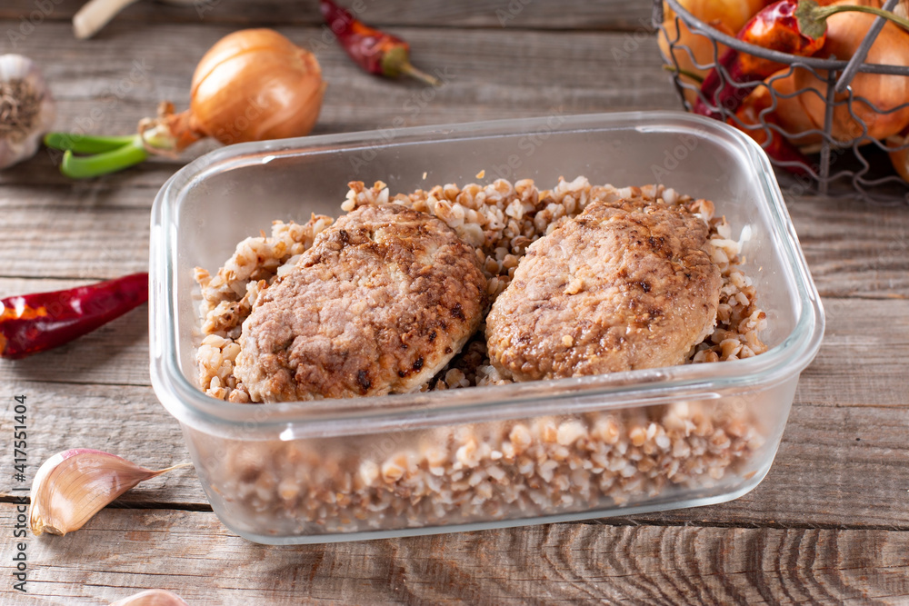 Cutlets and buckwheat in a container ready for freezing Cutlets and buckwheat in a container ready for freezing