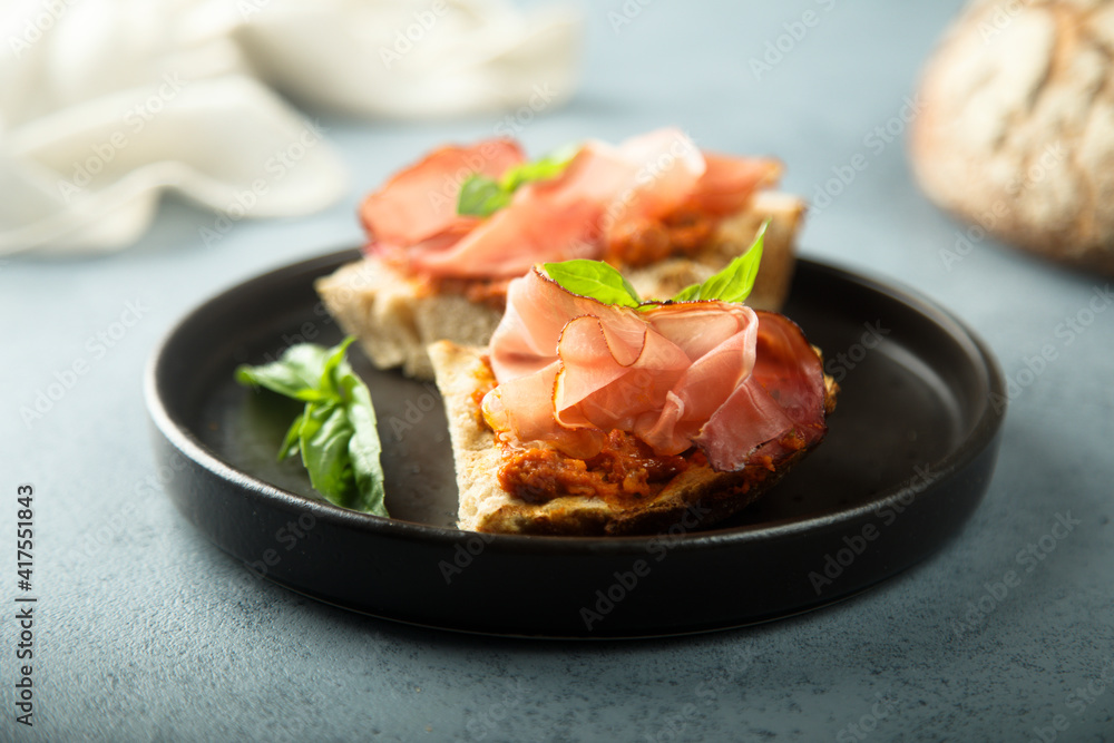 Homemade bruschetta with smoked meat and red pesto Homemade bruschetta with smoked meat and red pesto