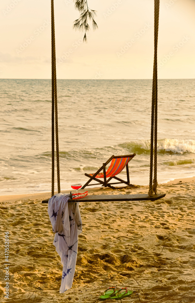 cocktail glass on the swing beach with blurred beach chair cocktail glass on the swing beach with blurred beach chair
