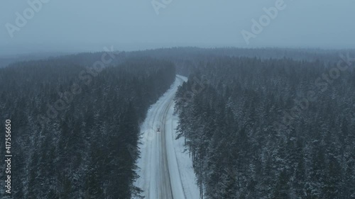 Taxi on a forest winter road. Aerial view.