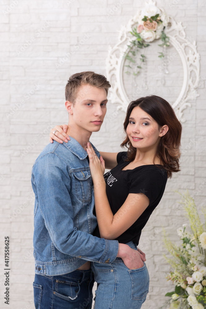 A young woman and young men in a romantic photo session, their love story.