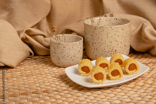 Delicious homemade pineapple roll tart for eid fitr on a with plate. Copy space