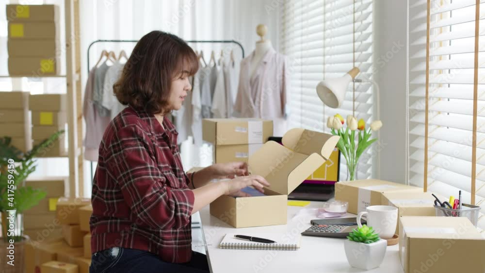Young attractive beautiful hipster asia female packing product small business parcel order online retail store for delivery to customer. SME owner work preparing dropshipping box at home office.