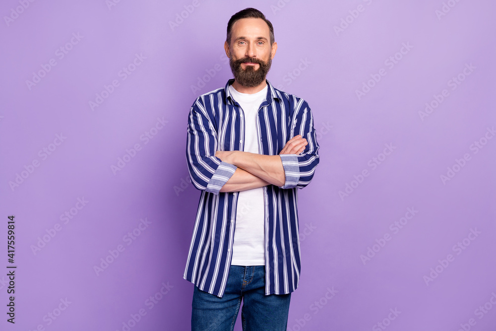Photo of mature man cross hands wear striped casual outfit isolated over violet color background Photo of mature man cross hands wear striped casual outfit isolated over violet color background