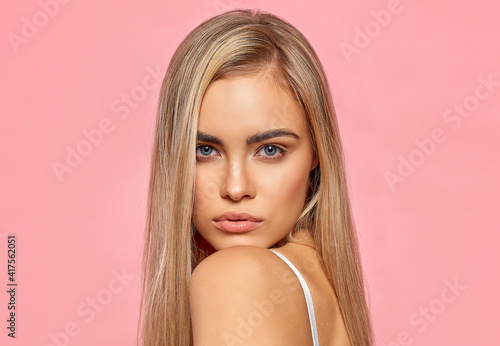Portrait of sexy blonde woman on pink background