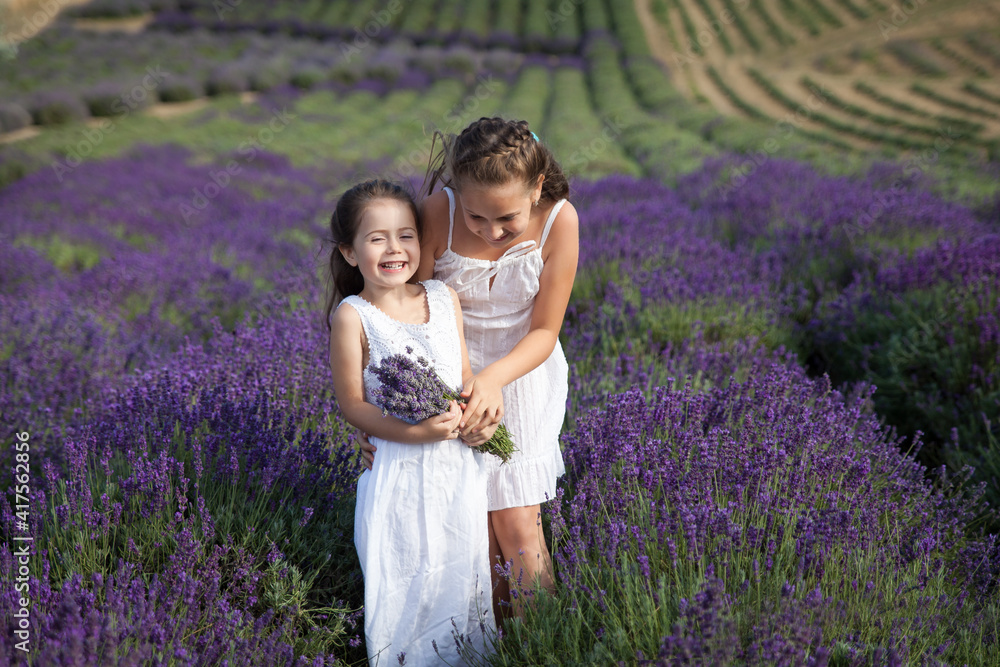 Cute sisters having fun in a lavender field Cute sisters having fun in a lavender field