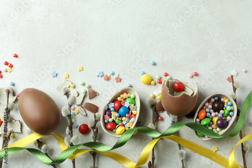 Easter concept with chocolate eggs on white textured background