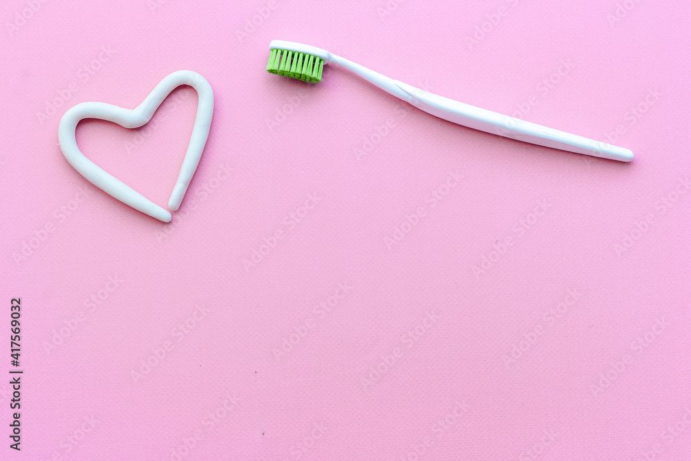 Heart shape of toothpaste with toothbrush, top view. Oral care and hygiene Heart shape of toothpaste with toothbrush, top view. Oral care and hygiene