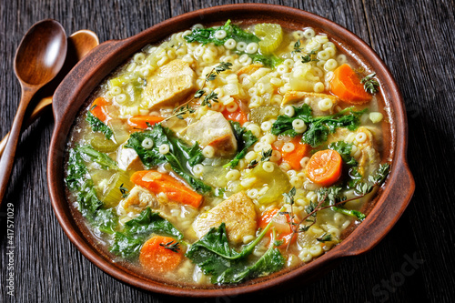 chicken kale veggies soup in a bowl