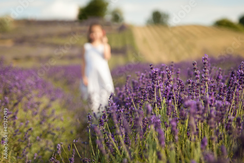 Cute little girl having fun in a lavender field © Olga Gorchichko