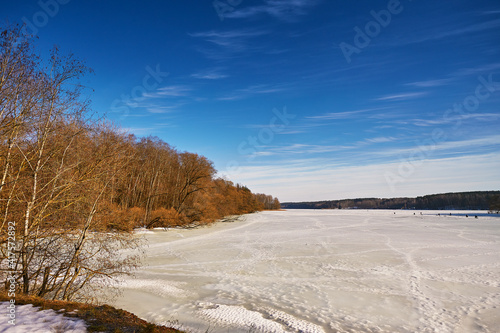 Early Spring With Melting Ice And Snow. Nature in March. Lake and forest rural scene