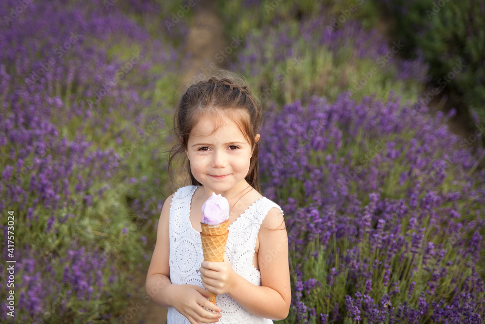 Cute little girl having fun in a lavender field