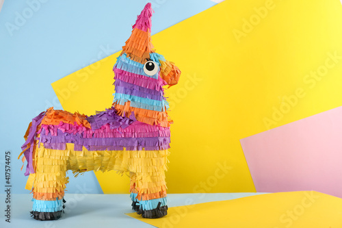 llama shaped pinata on color background. Space for text photo