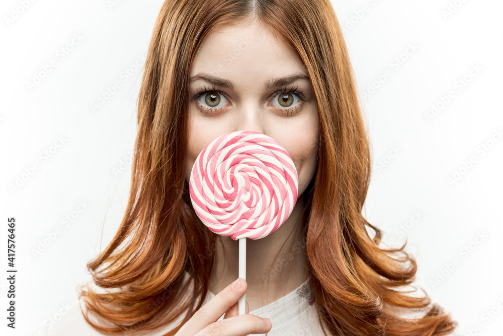woman with lollipop in her hands red hair enjoyment fun