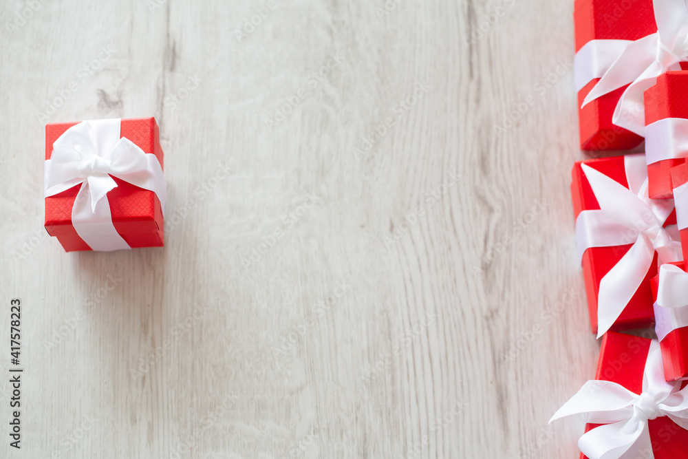 Red gift boxes on white wooden floor