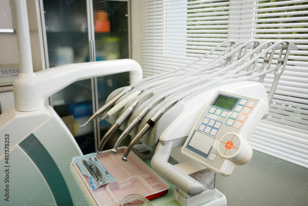 partial view of dentist's chair, with window in the background partial view of dentist's chair, with window in the background