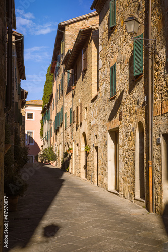 Narrow street with medieval houses  San Quirico d Orcia  Italy