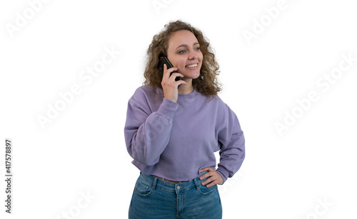 Young woman talking on the phone while she looks aside on white background.