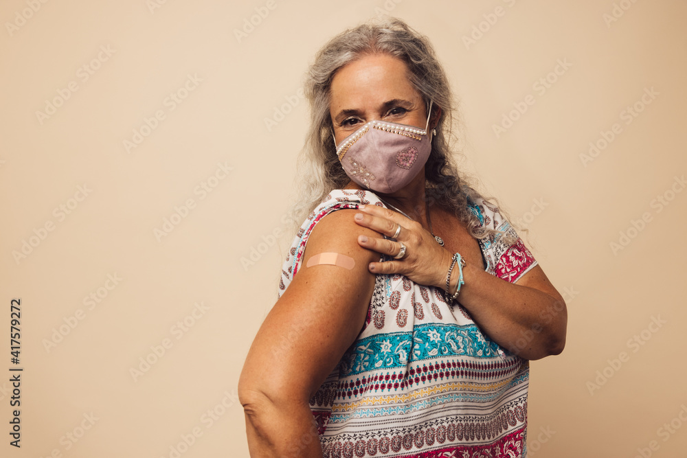 Woman showing her arm after getting vaccine
