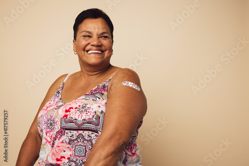 Senior woman smiling after getting vaccination