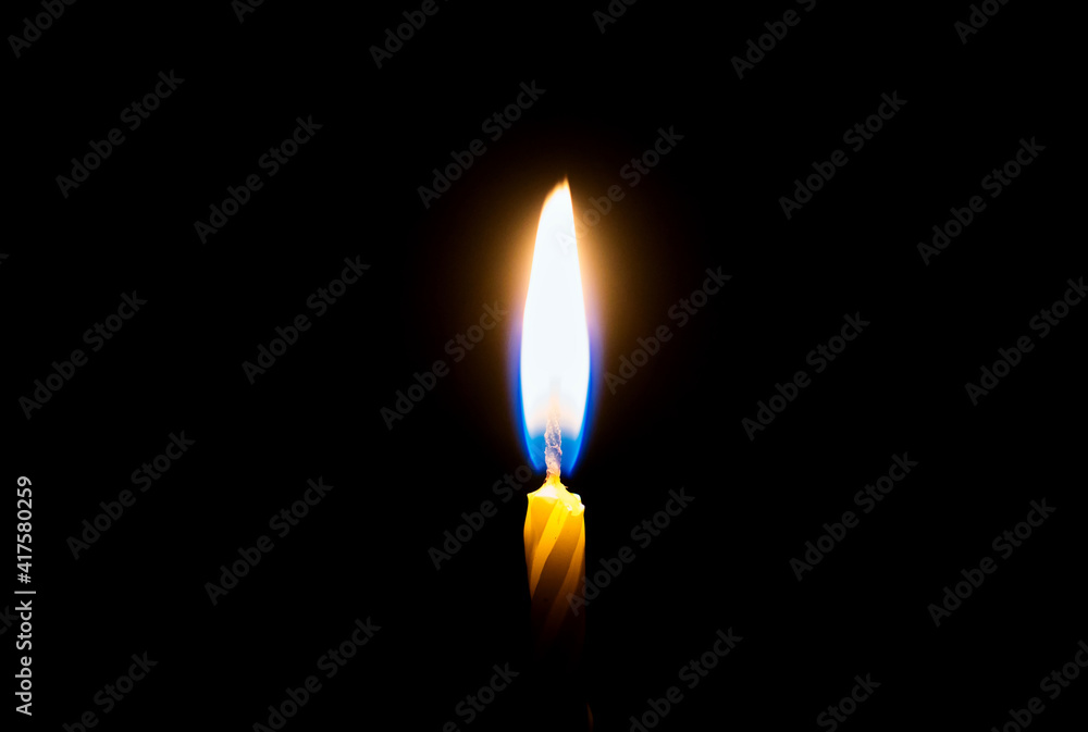 flames burning in the dark candle. close-up flames burning in the dark candle. close-up