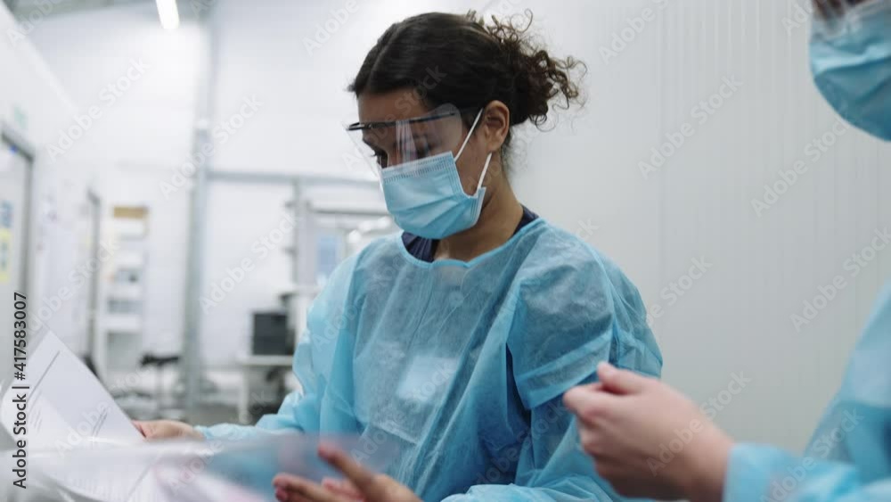 Doctors In Face Masks Checking Paperwork Doctors In Face Masks Checking Paperwork